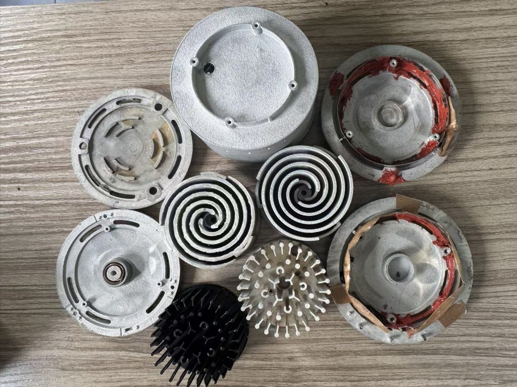 Parts from the three early prototypes, laid out on a table.